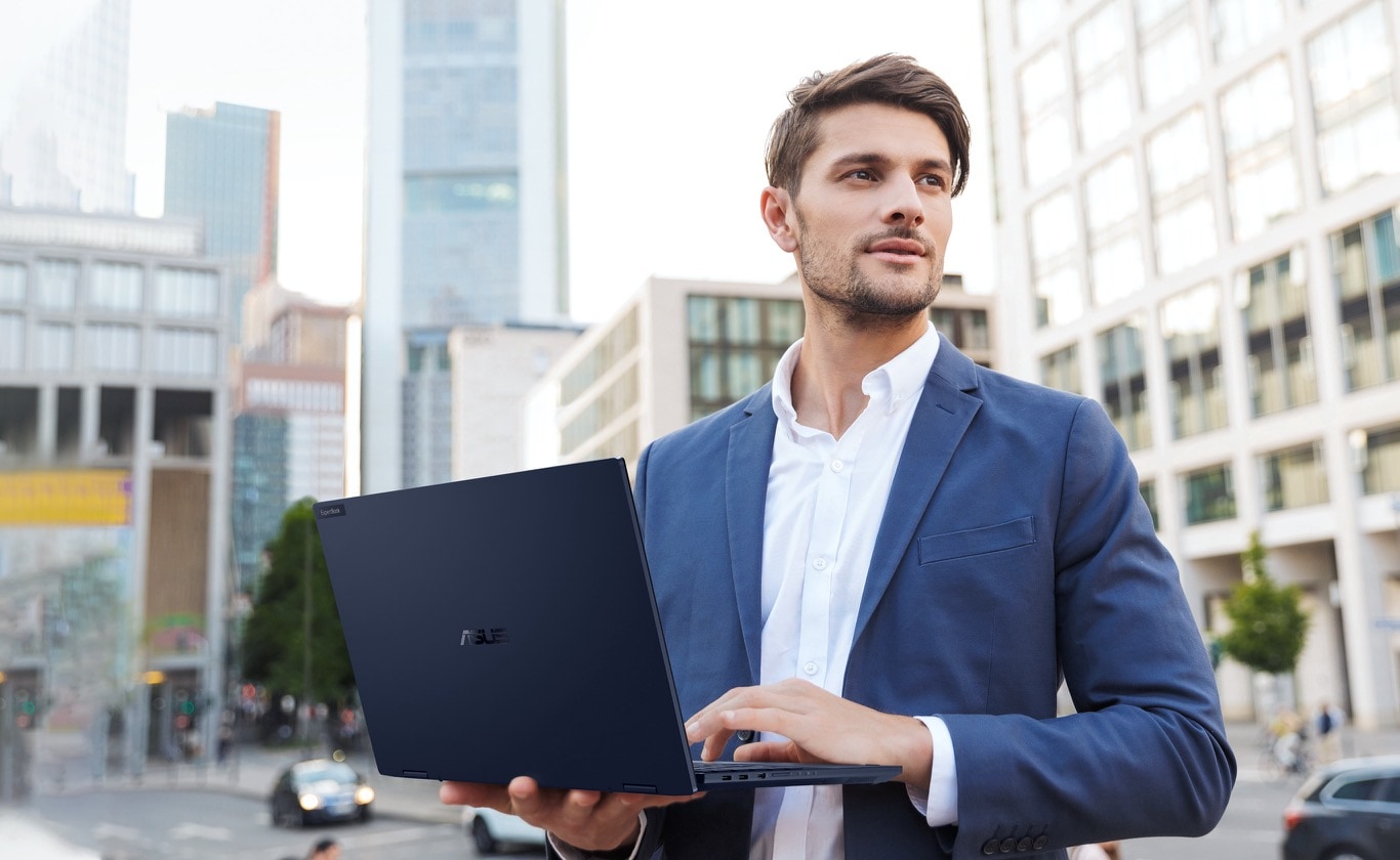 Man in business suit holding ASUS ExpertBook B5