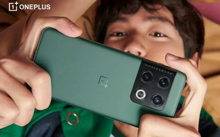 OnePlus phone in green from rear with person looking at it