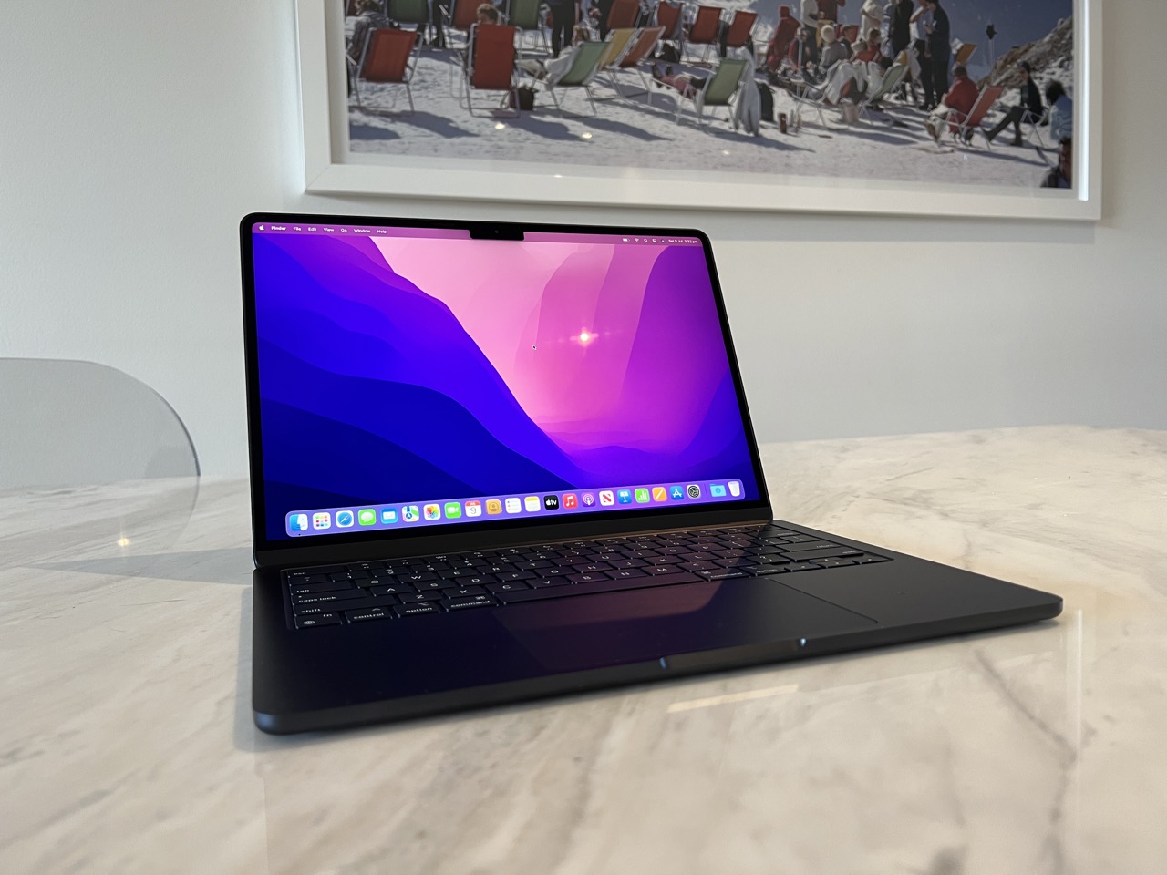 laptop on table with picture in background